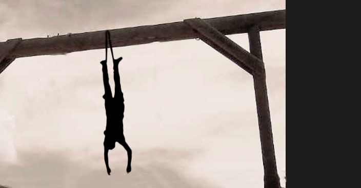 Silhouette of man hanging upside down