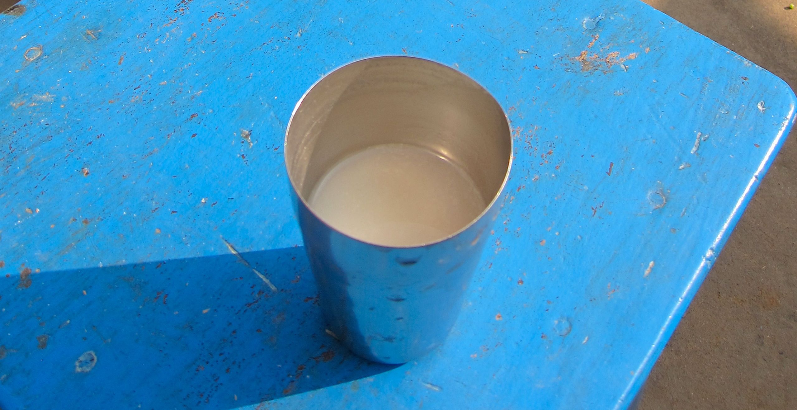 White drink in metal cup