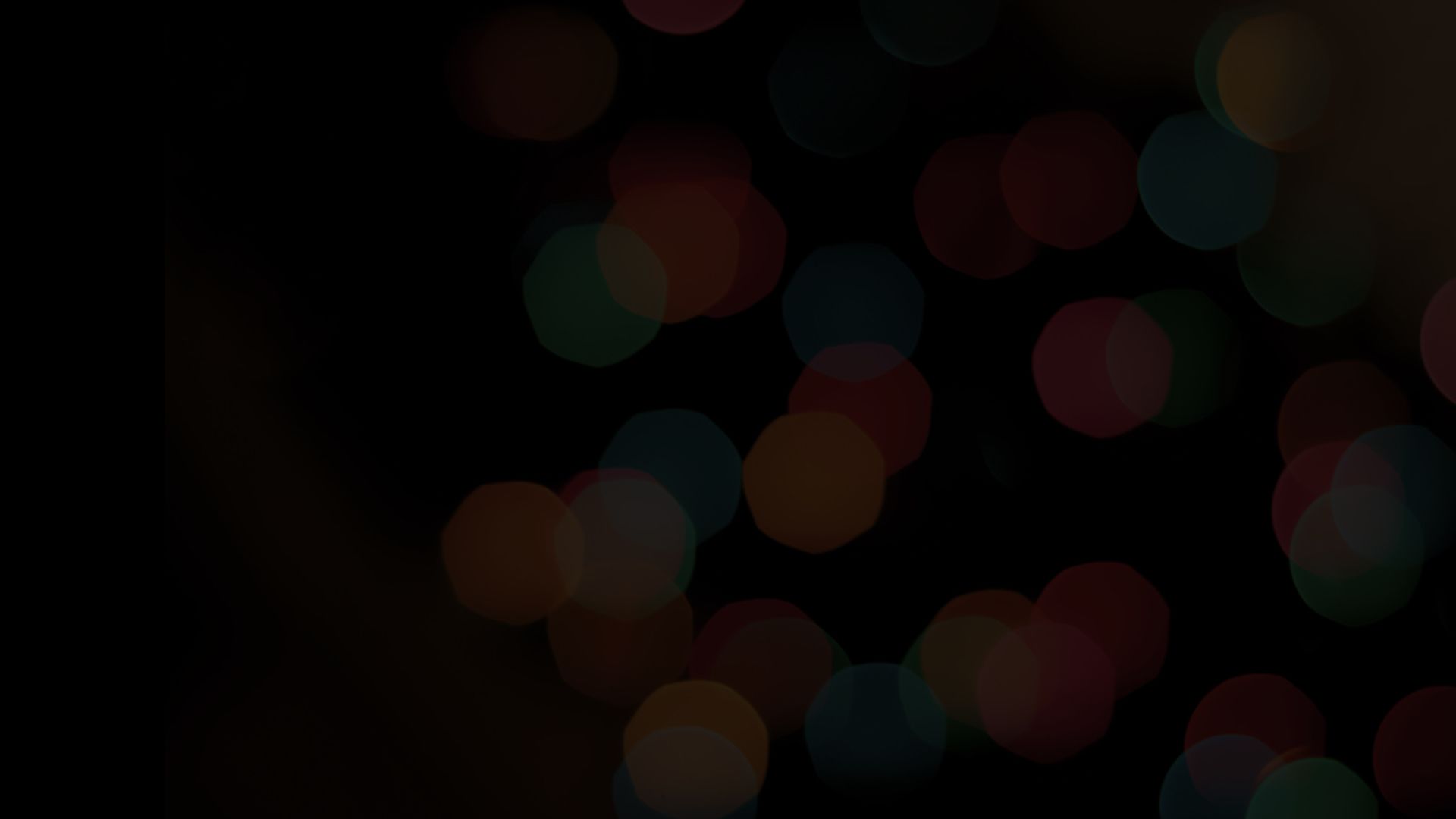 Dim red circles against dark background